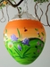 Osterei, orange, Hase mit Osternest auf Blumenwiese